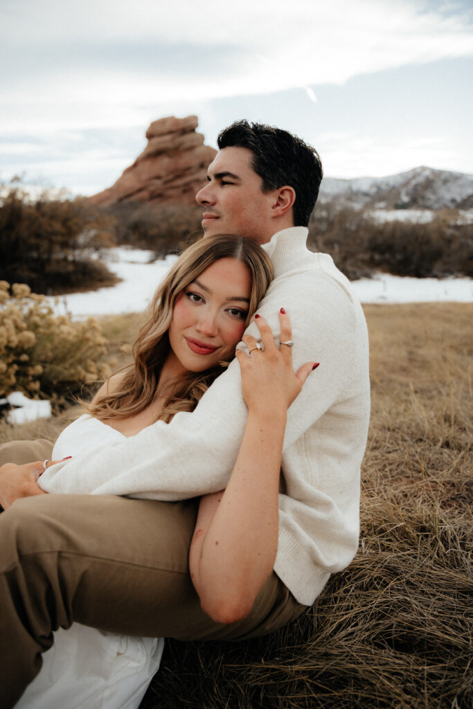 red rocks in the distance of a engagement portrait