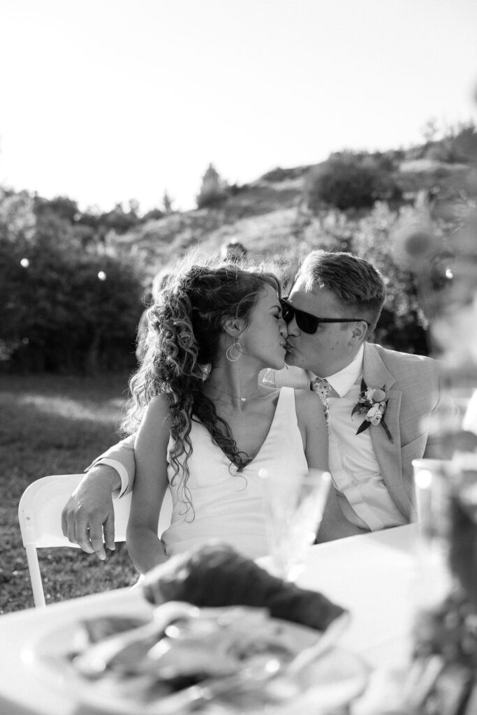 kisses at mountain wedding in summer